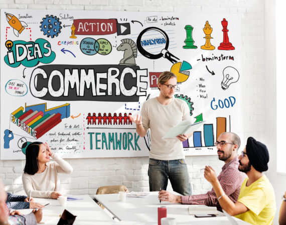 commerce-business-marketing-strategy-finance-concept Photo of a startup with staff sitting down in front of a whiteboard talking about commerce and brainstorming.